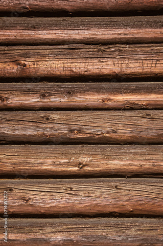 The wooden wall of a village house. Horizontal logs background