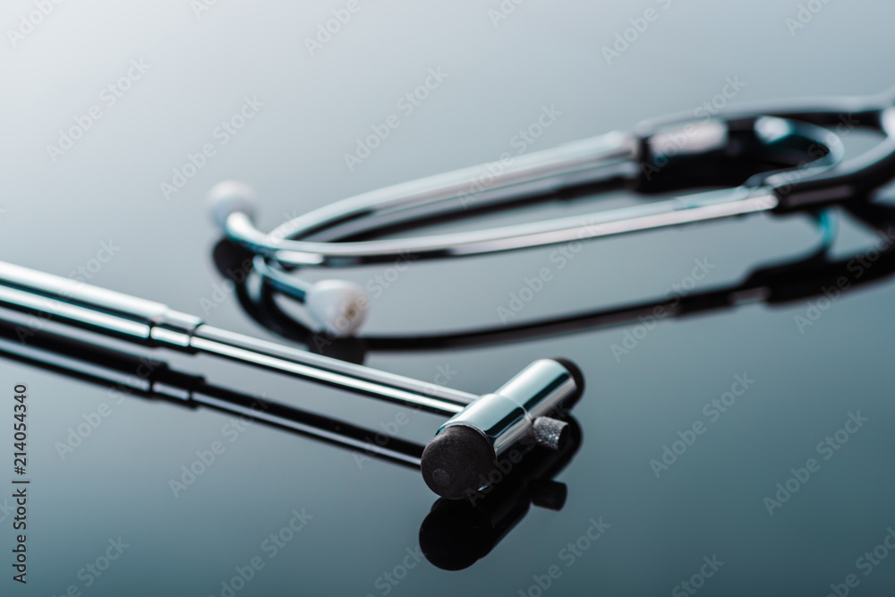 selective focus of reflex hammer and stethoscope on glass surface selective focus of reflex hammer and stethoscope on glass surface