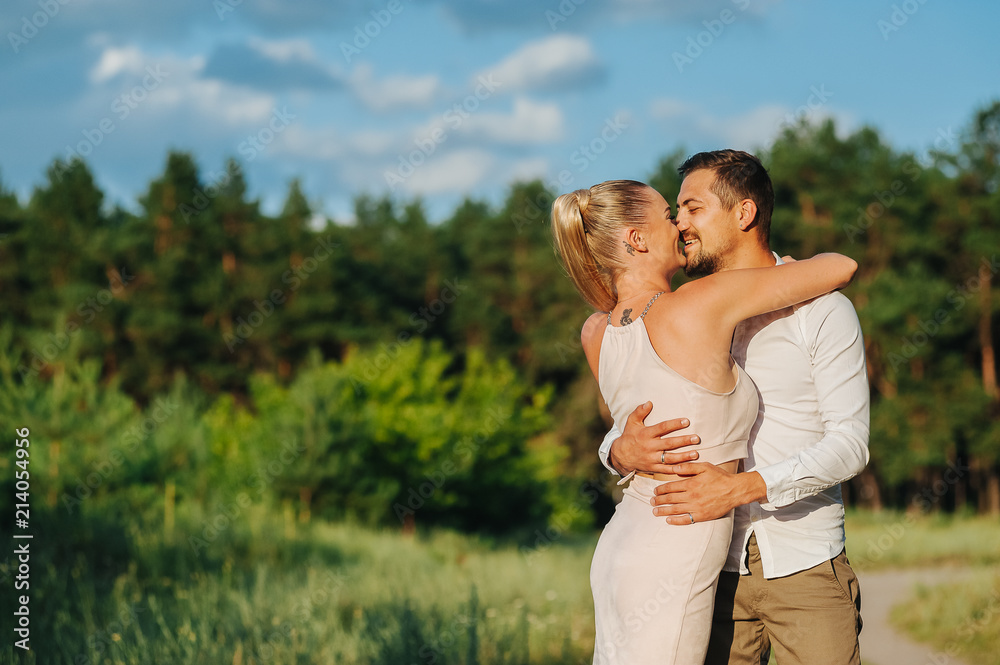 Vacation. Happy couple spending time and hugging and about to kiss in beautiful sunset. Loving young man and woman on the nature Vacation. Happy couple spending time and hugging and about to kiss in beautiful sunset. Loving young man and woman on the nature