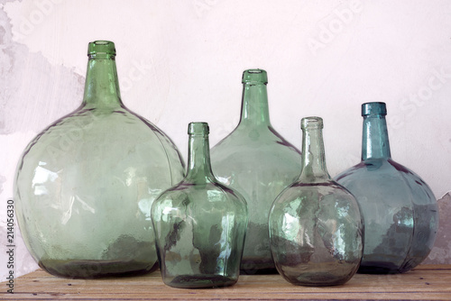 Green glass carafes on white background. Copy space