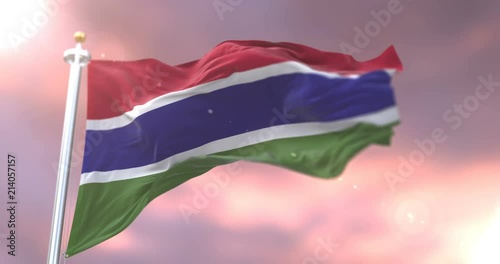 Flag of Gambia waving at wind in slow at sunset, loop photo