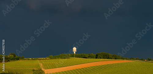 Colorful rainbow and storm in the sky above bordeaux vineyard photo
