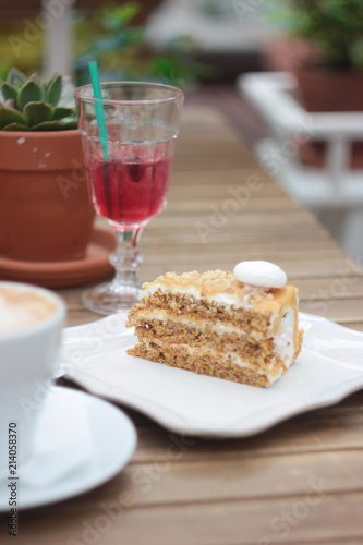 The piece of cake on table of summer terrace in cafe, picnic, set table