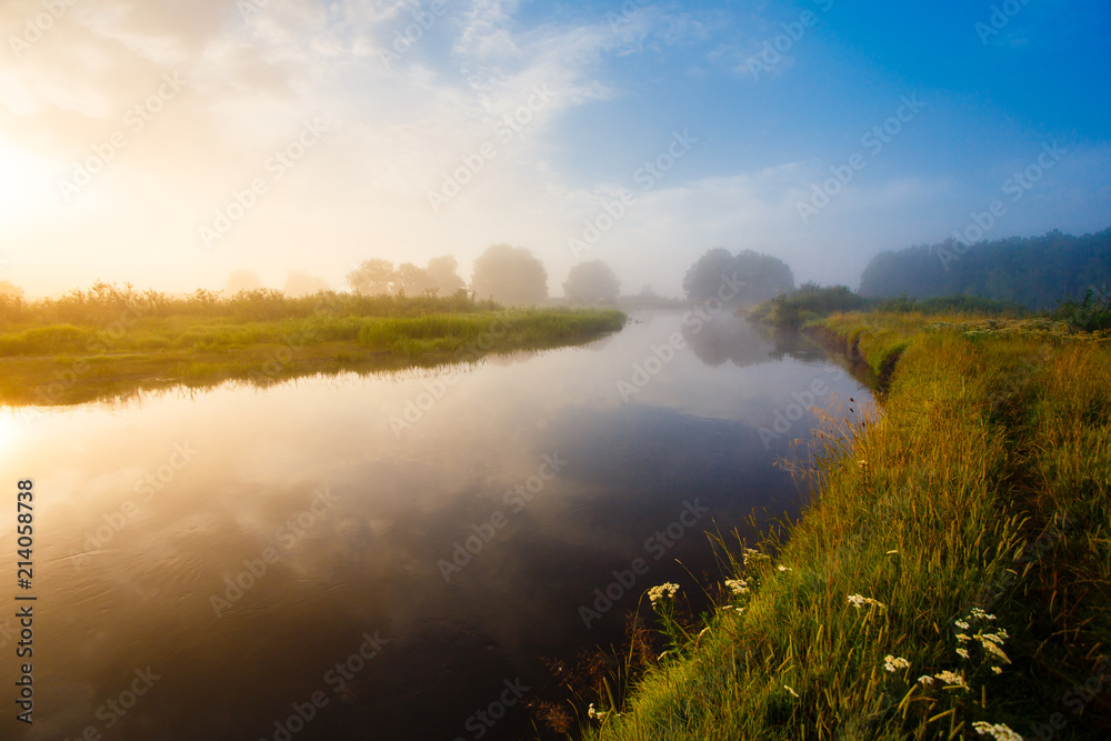River curve at sunrise landscape. Thick fog over the river in the countryside