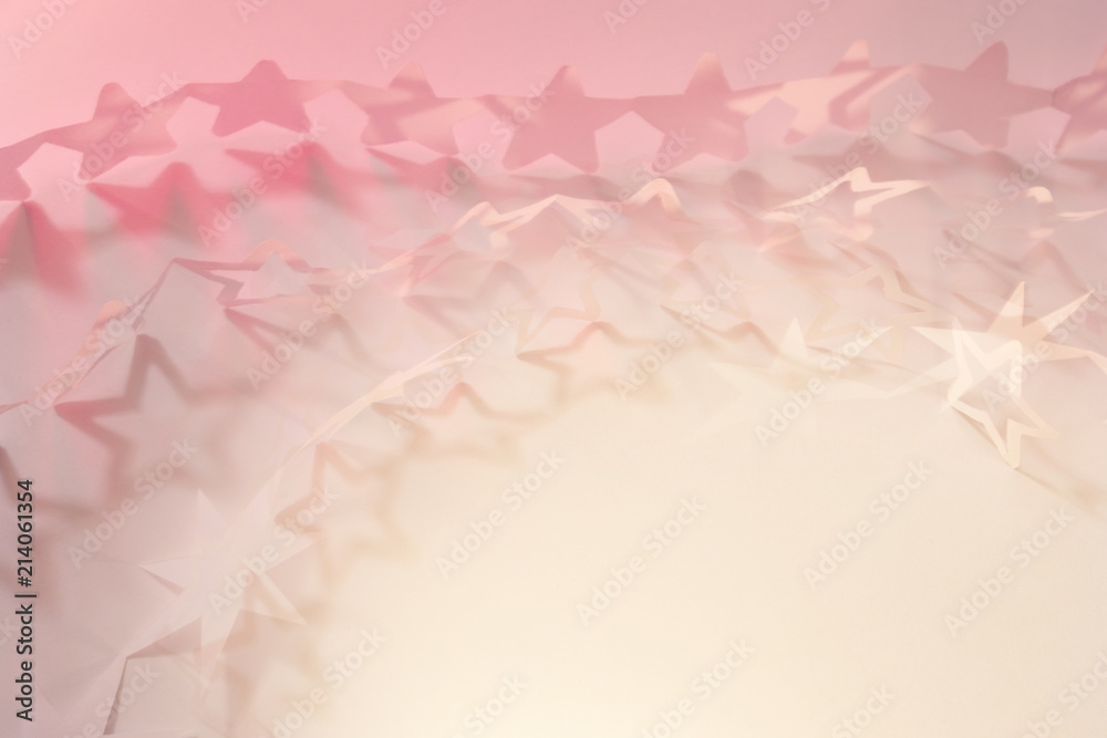 Paper cut star chains in different shapes, with playful shadows and a glowing space in the corner Paper cut star chains in different shapes, with playful shadows and a glowing space in the corner
