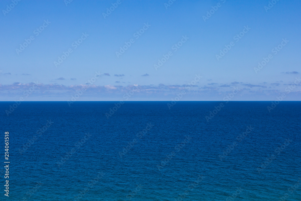 summer background - blue sea and sky with clouds