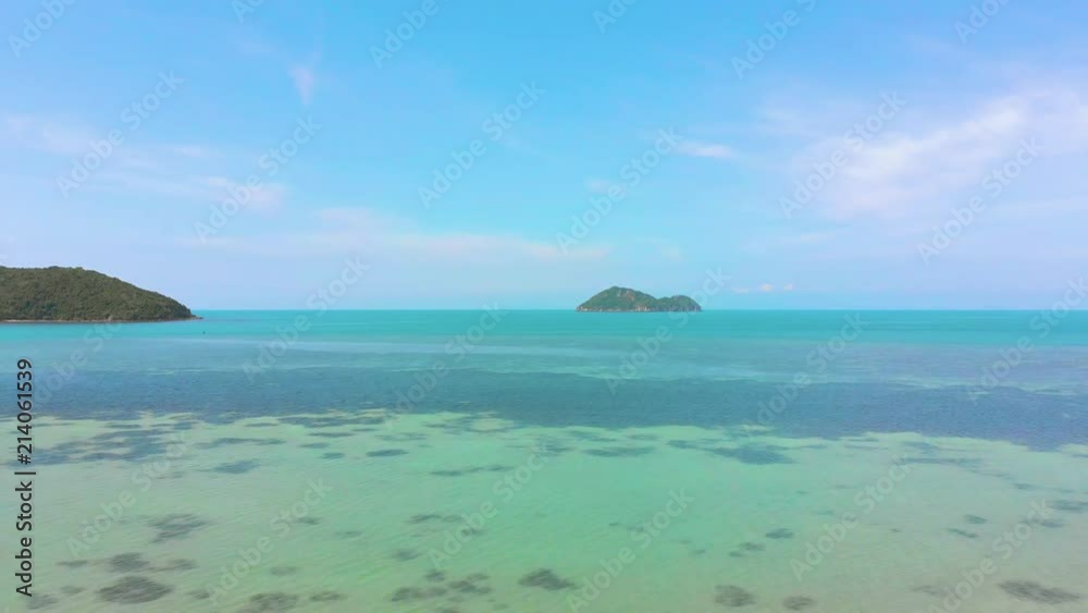 Flying over water with islands and blue sky on background Flying over water with islands and blue sky on background