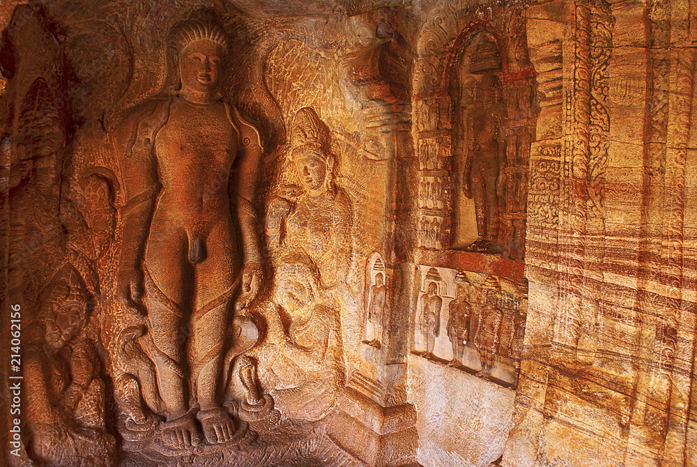 Cave 4 : Carved figure of Bahubali with his lower legs surrounded by snakes, together with his daughters Brahmi and Sundari
