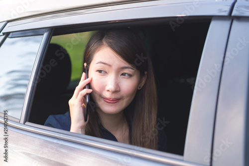 Business Woman Uses Smartphone While sitting in car