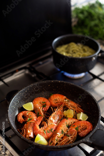 Roasted tiger shrimps with spice and lime in the stove. Grilled seafood from mediterranean kitchen