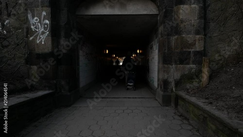 People walking in dark tunnel photo
