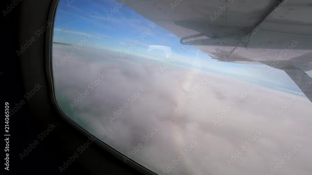 Flying low over clouds timelapse on the way to a small northern Manitoba community. Flying low over clouds timelapse on the way to a small northern Manitoba community.