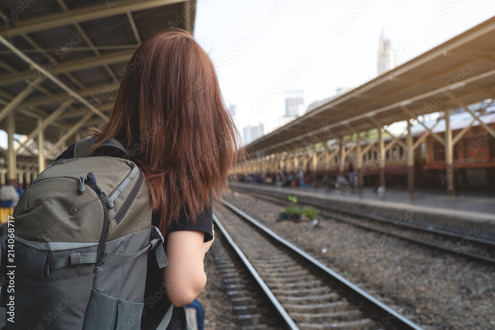 Young woman traveler  in train station platform, travel concept