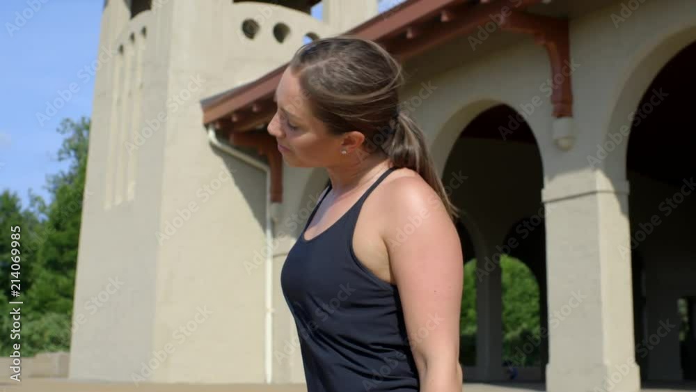 Athletic girl training in the park stretches at the steps of the World's Fair Pavilion in Forest Park, St. Louis. Athletic girl training in the park stretches at the steps of the World's Fair Pavilion in Forest Park, St. Louis.