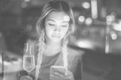 Woman using a smartphone at a rooftop bar