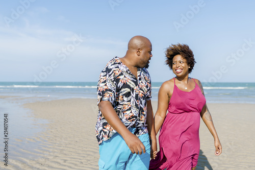 African American couple walking at the beach