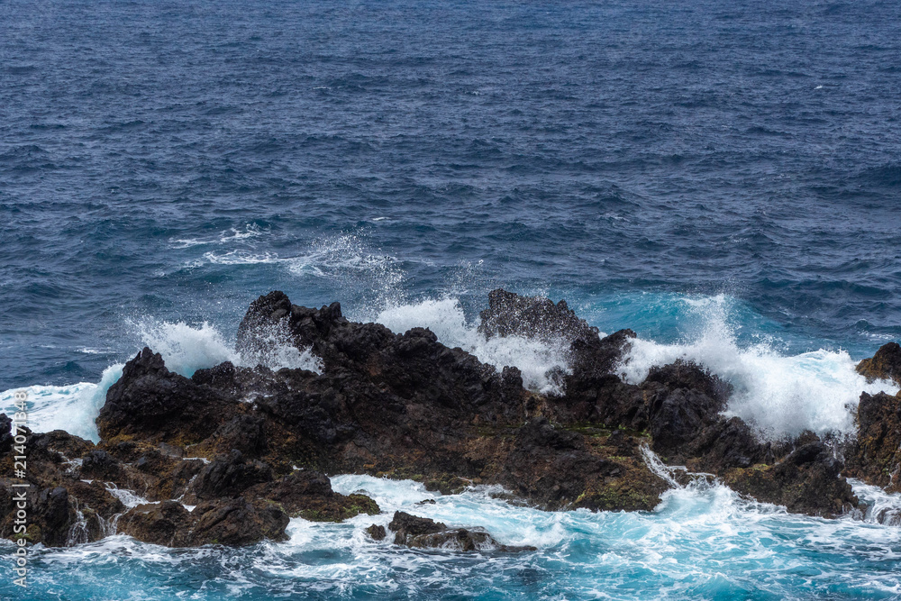 Waves crashing against a rocky coast in Atlantic ocean