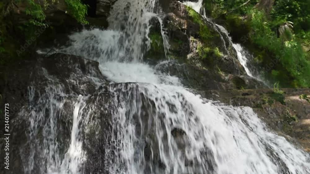 Waterfall in mountains at summer, natural outdoor travel concept. Slow motion Waterfall in mountains at summer, natural outdoor travel concept. Slow motion