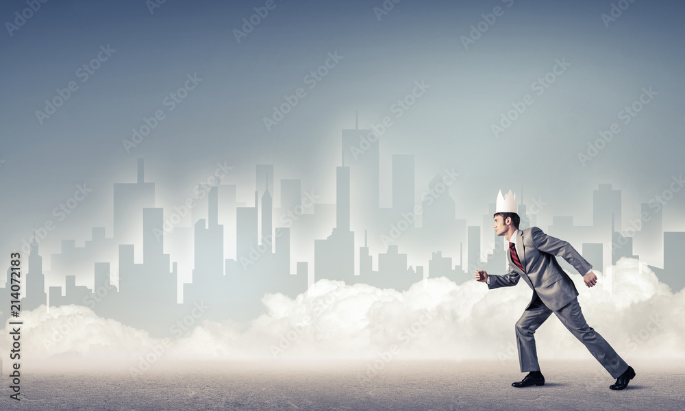 King businessman in elegant suit running and blue cityscape silh King businessman in elegant suit running and blue cityscape silh