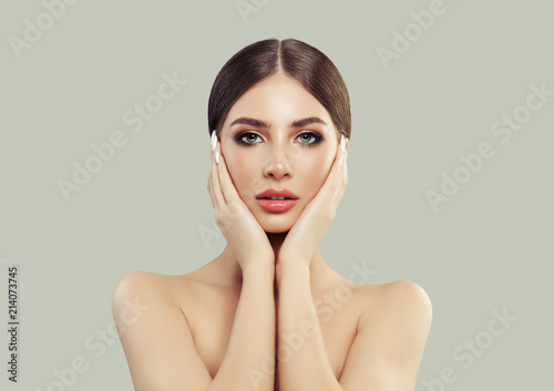Beautiful Young Woman Holding her Face in her Hands. Plastic Surgery and Facial Treatment Concept
