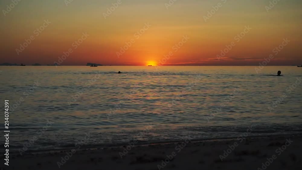 Silhouettes moving at sea on sunset background. Golden sunset at sea Silhouettes moving at sea on sunset background. Golden sunset at sea