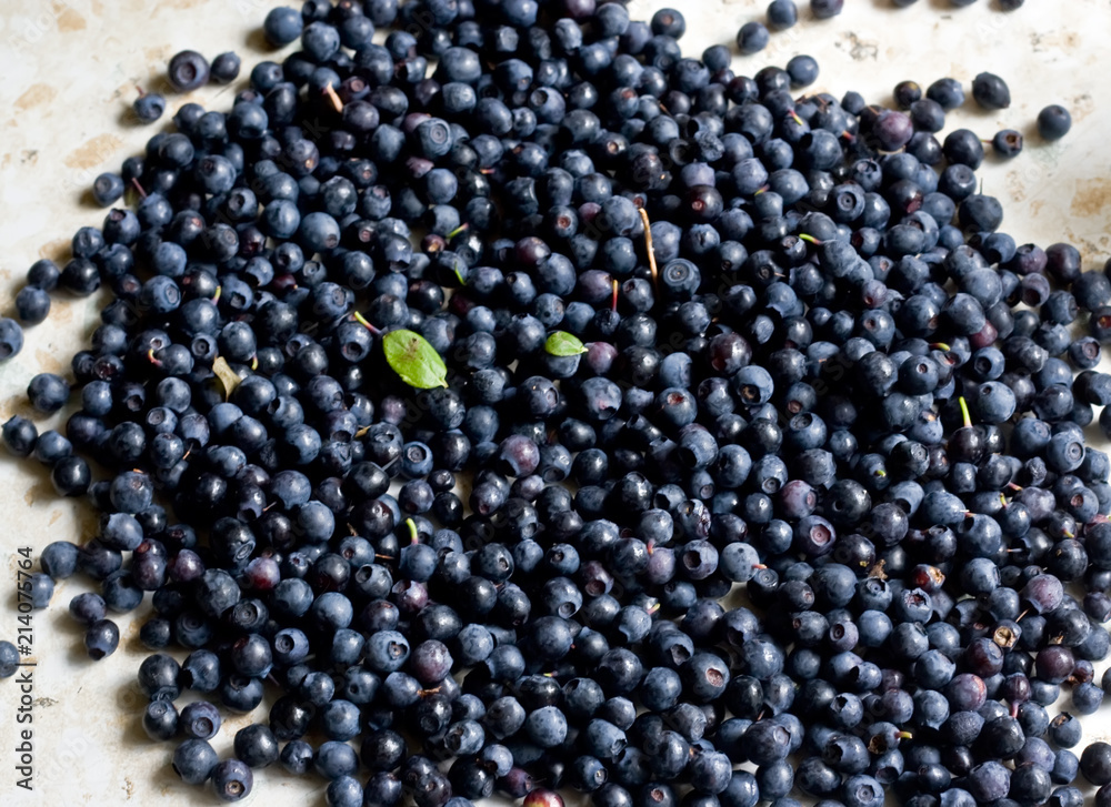 A lot of blueberries lie on the table A lot of blueberries lie on the table