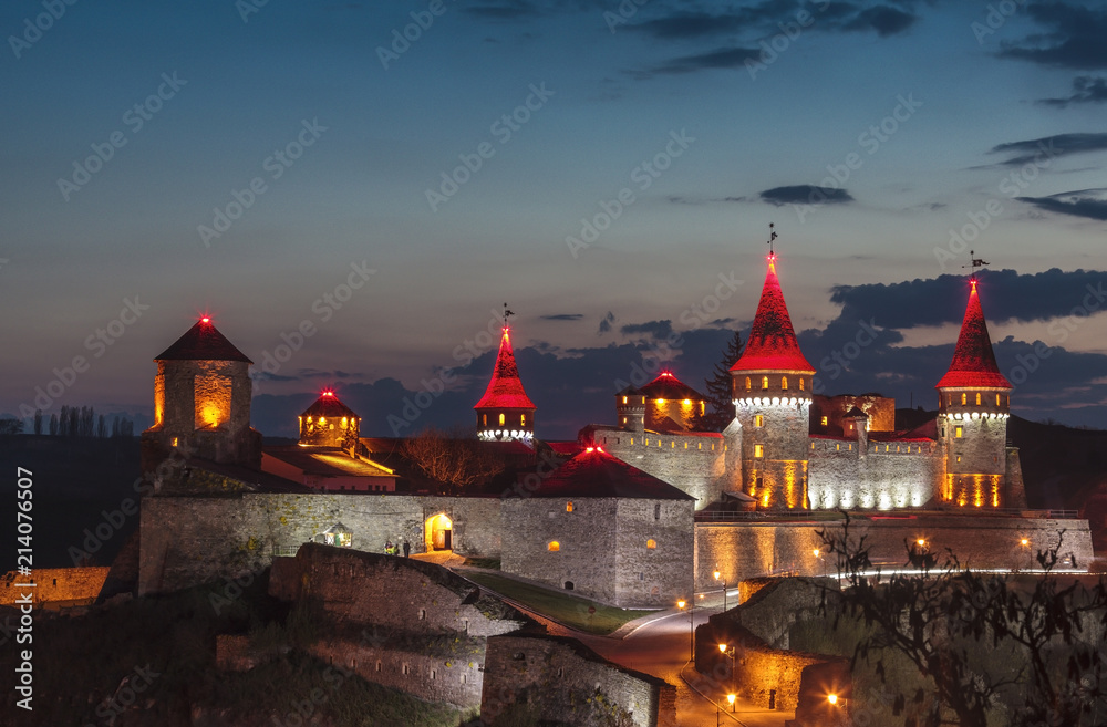 Evening view of the medieval fortress in Kamianets-Podilskyi, Ukraine. Evening view of the medieval fortress in Kamianets-Podilskyi, Ukraine.