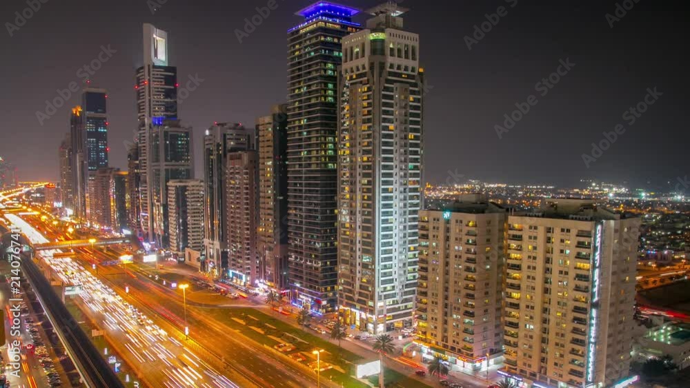 Day to night transition over Dubai street with skyscrapers. Day to night transition over Dubai street with skyscrapers.