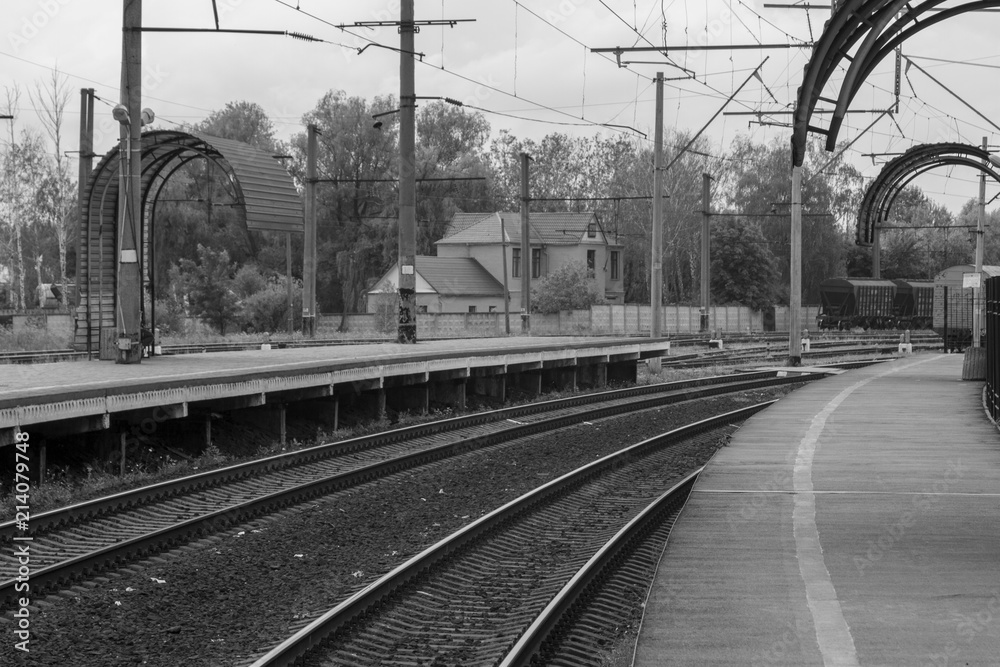 Railroad tracks for the train. In the area of the pen. Brilliant rails go nowhere. Black and white photo of the railway platform.