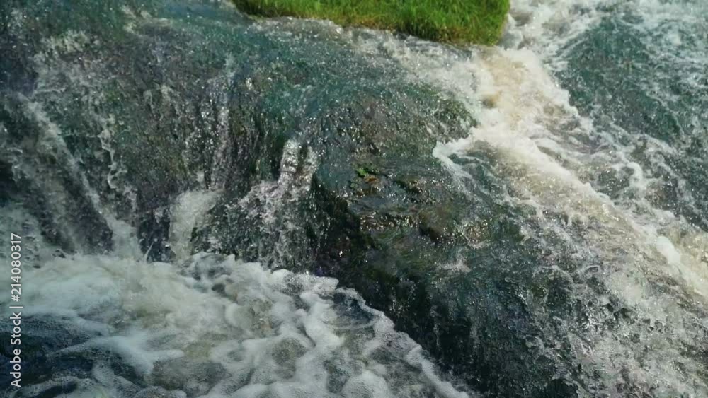 Small Waterfall Cascading over Rocks in Tropical Forest. Slow motion