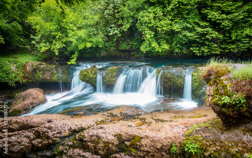 Amazing forest waterfall flowing into the cold mountain river. Martvili canyon. Nature fall