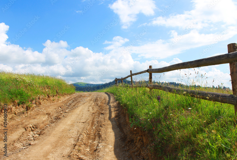 Landscape with a country road and a fence.