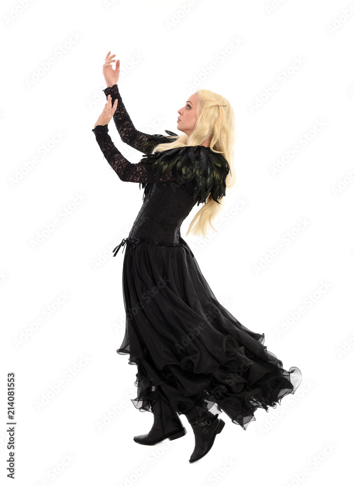 full length portrait of blonde girl wearing corset and long black gown. isolated on white studio background, full length portrait of blonde girl wearing corset and long black gown. isolated on white studio background,