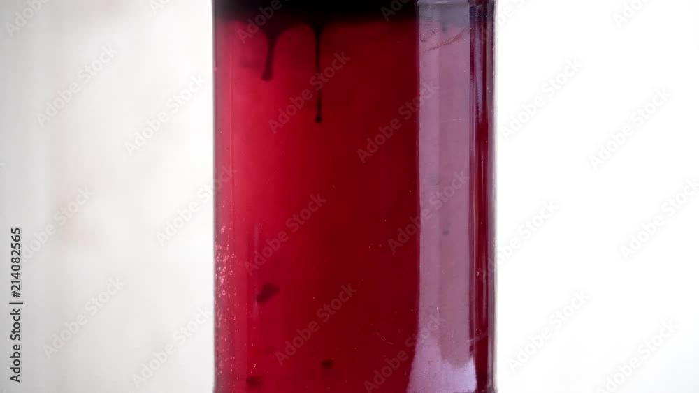 Blood dripping in clear liquid science experiment isolated close up no people 