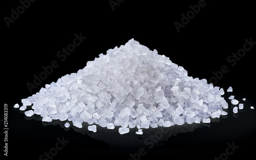 heap of salt isolated on black background.