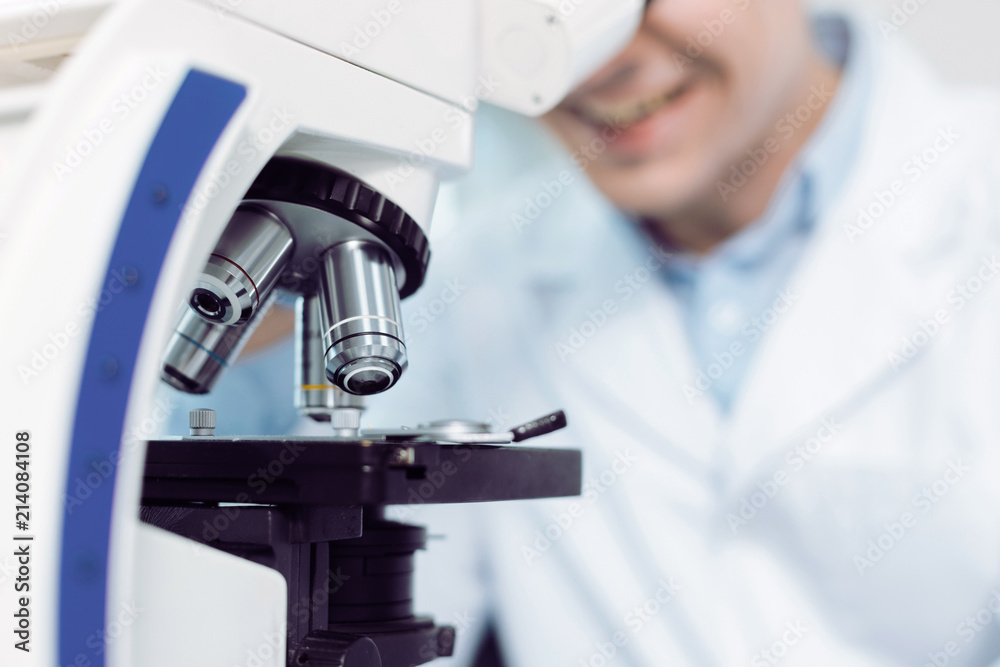 Optical lenses. Selective focus of details of a modern professional microscope being used for biological research Optical lenses. Selective focus of details of a modern professional microscope being used for biological research
