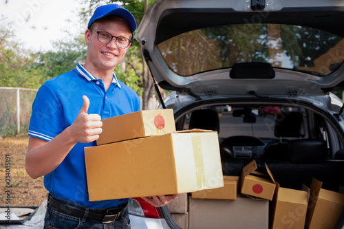 Delivery man show thumb up to service delivering package box , delivery concept