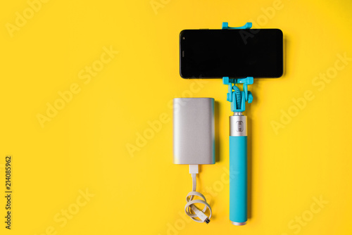 Set for photographing and traveling monopods with smartphone for selfie and power bank. Stick with smartphone isolated photo