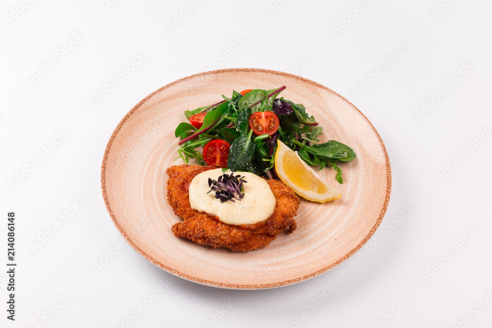 Top and front view isolated - Chicken parmesan cheese and mixed salad. Top and front view isolated - Chicken parmesan cheese and mixed salad.