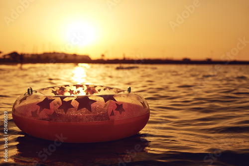 An inflatable circle for swimming in the sea on a beautiful sunset.