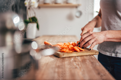 Woman cutting carrot