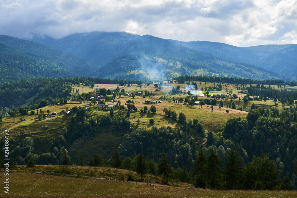 Fototapeta premium Mountains with forests and village