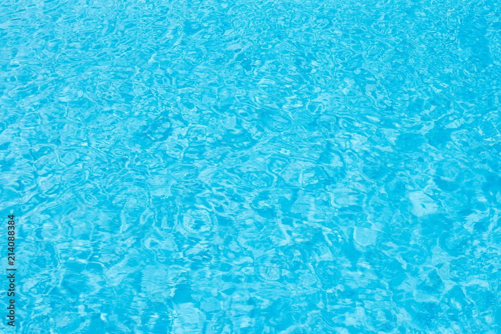 Ripple Water in swimming pool with sun reflection for background.