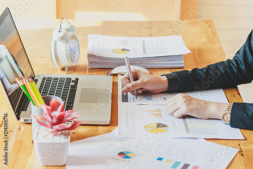 Asian Business woman working at office with documents paper on desk.