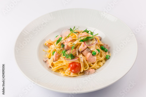 Front and top view isolated - Tagliatelle with salmon and tomatoes. 