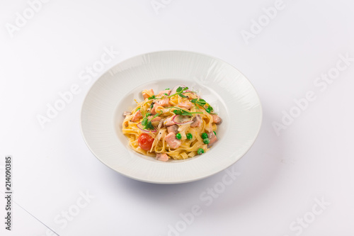 Front and top view isolated - Tagliatelle with salmon and tomatoes. 