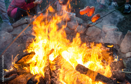 Grilling meat on a fire.