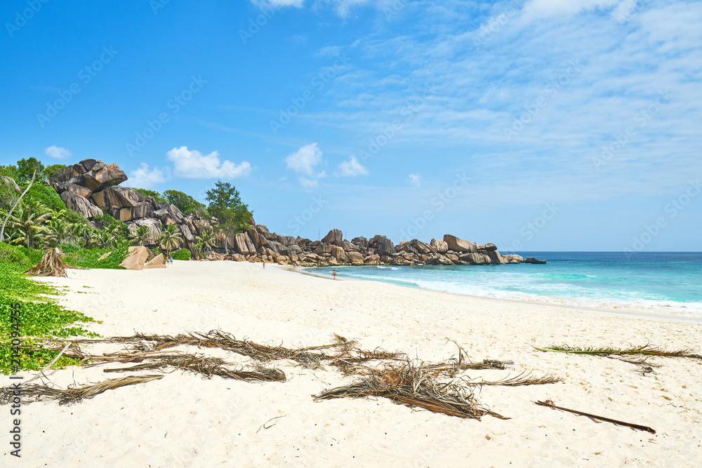 Beautifully shaped granite boulders and a perfect white sand at Grand Anse, La Digue island, Seychelles