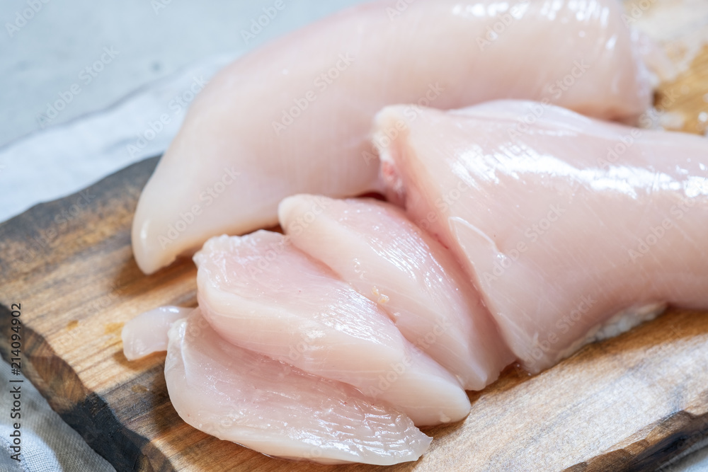 Fresh chicken meat on wooden board Fresh chicken meat on wooden board