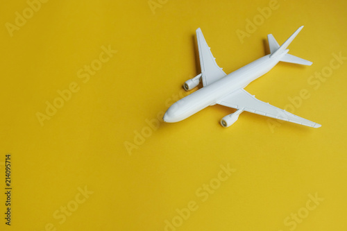 Copyspace of white airplane on yellow background